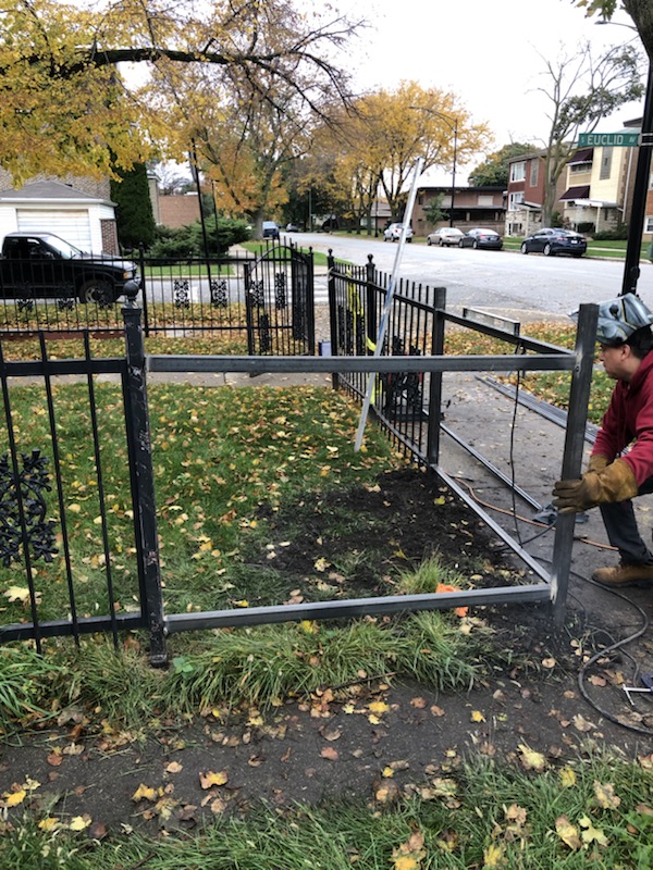 Decorative steel fence section being framed and fit on site before final finishing.