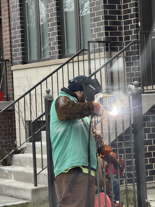 On-site welding during exterior railing and front-entry repair.