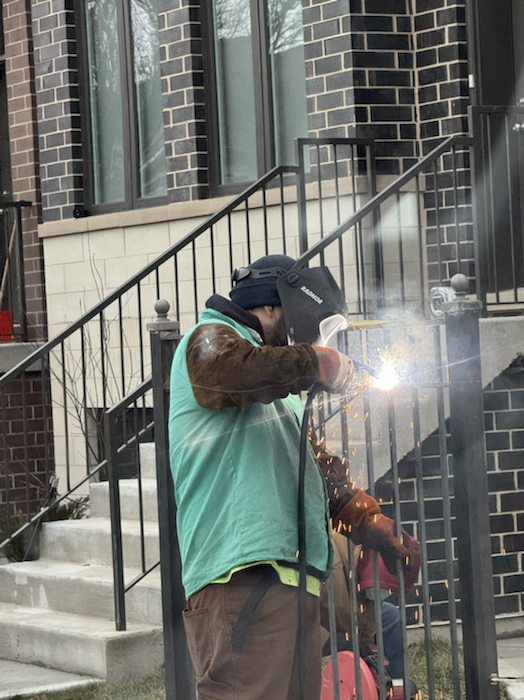 On-site welding work during exterior metal railing repair at a residential property.