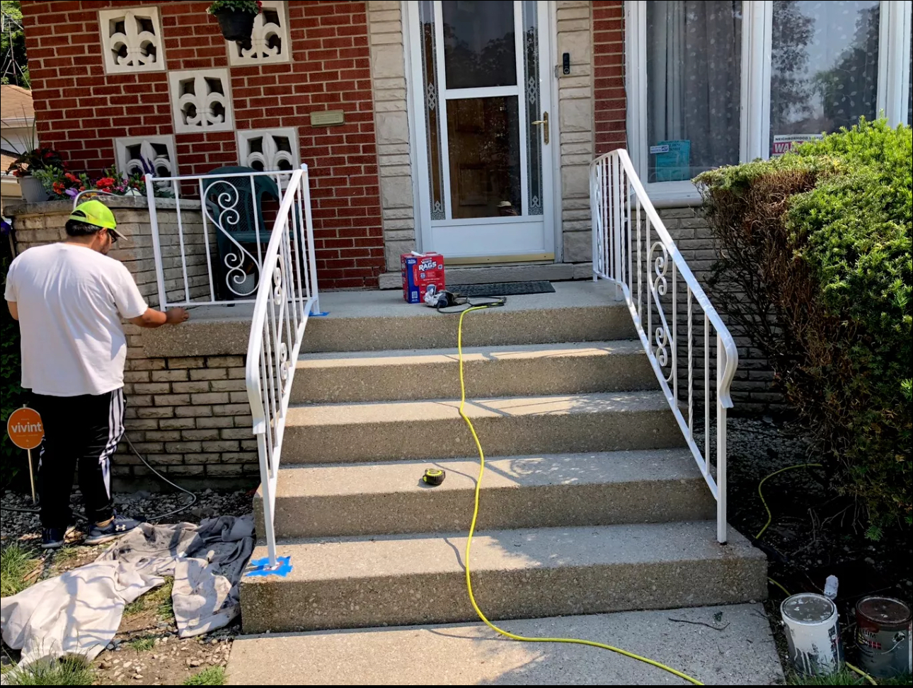 White front-step metal handrails after refresh and repair work.