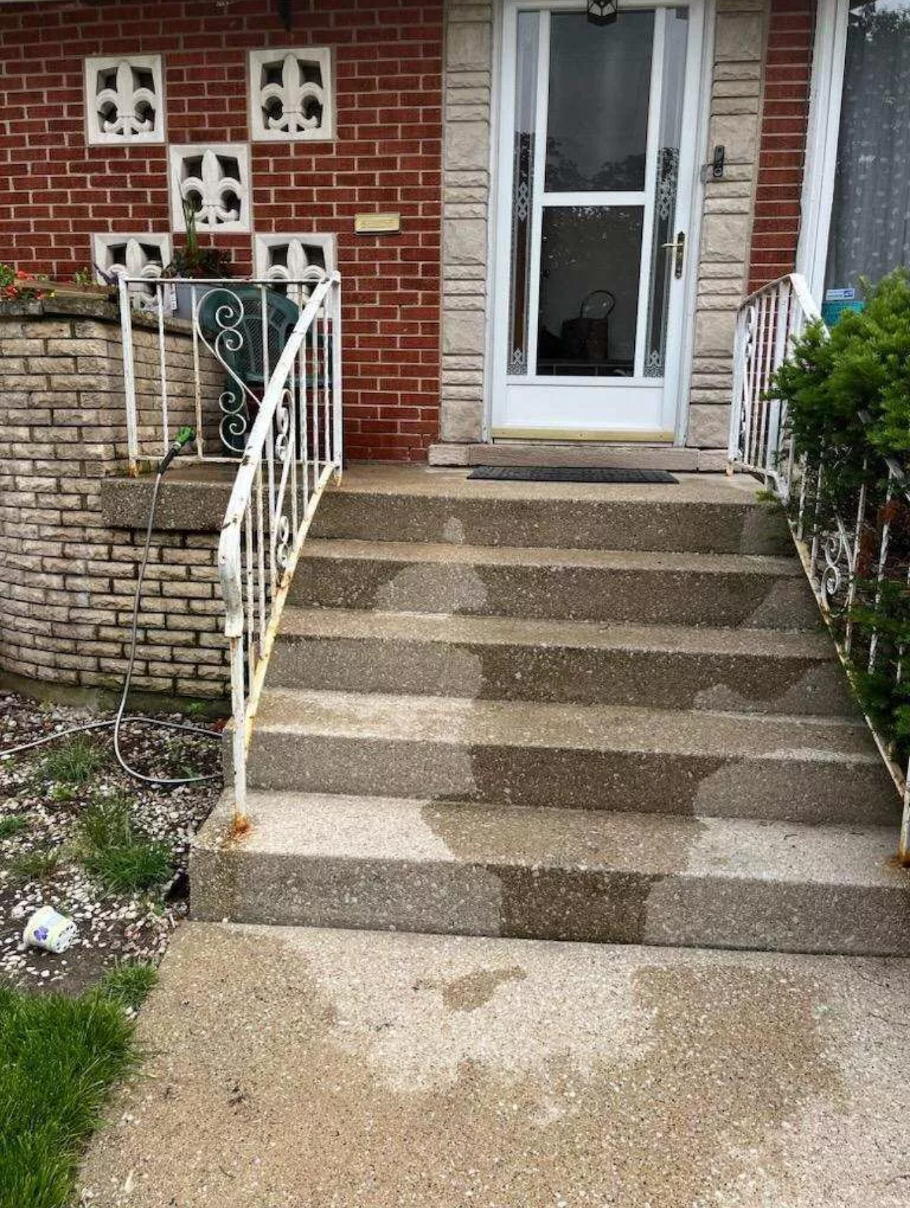 Older white metal porch handrails before repair or refresh work.