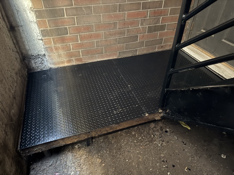 After photo of a new steel landing plate installed and fitted for a safer exterior platform.